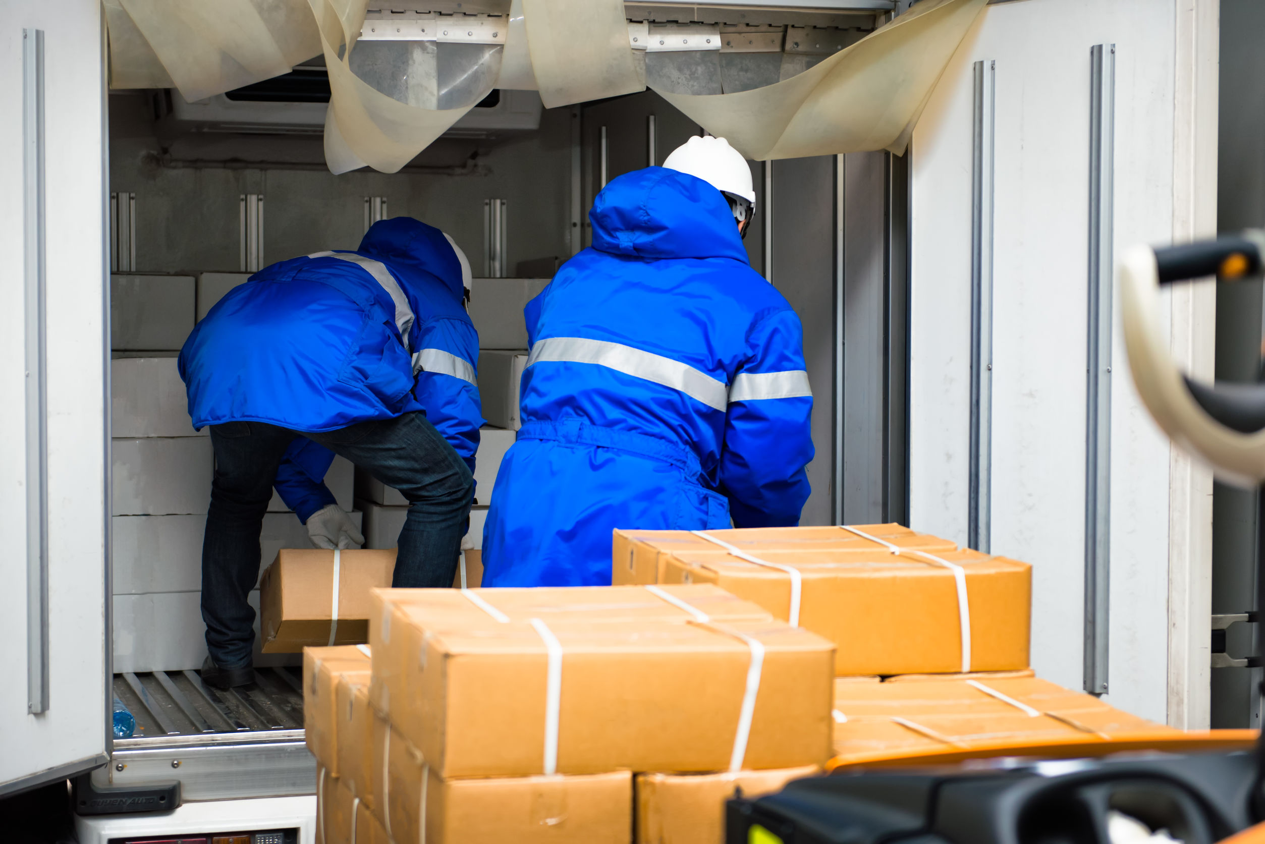 warehouse-003 Manual worker working with package boxes for transport by pickup at gates for goods in loading area from warehouse to be processed export to customer
